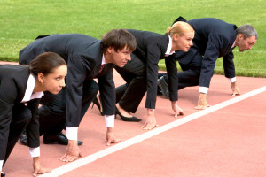 Confident business people lined up getting ready for race