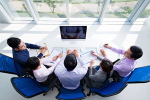 Colleagues sitting in front of the monitor in the office